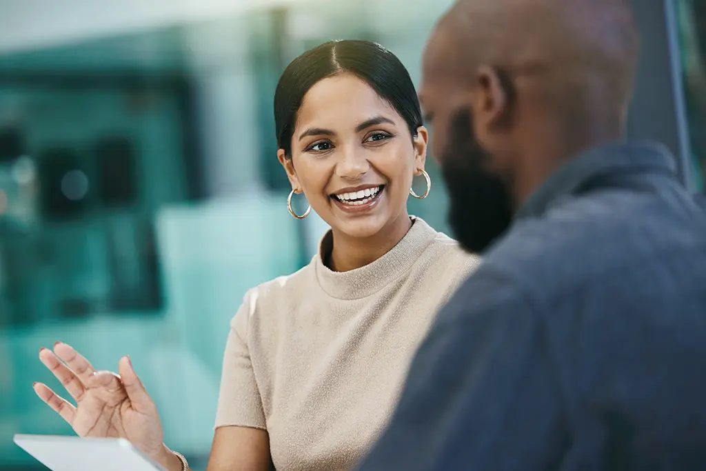 Shot of a businesswoman discussing cost containment for healthcare system in a meeting with her colleague